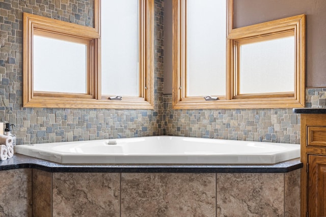 full bath featuring decorative backsplash and a bath