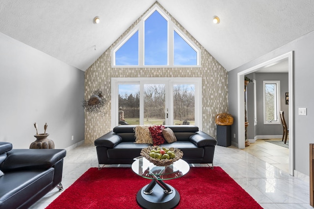 living room with high vaulted ceiling, marble finish floor, baseboards, and a textured ceiling