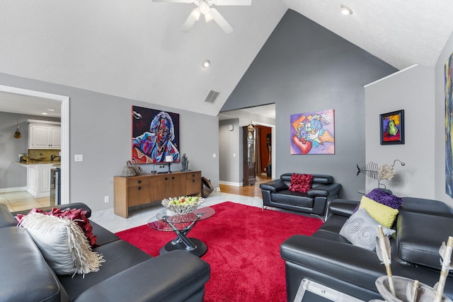 living area with ceiling fan, high vaulted ceiling, recessed lighting, visible vents, and baseboards