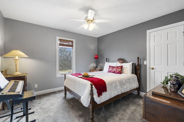 bedroom with a ceiling fan, carpet flooring, and baseboards