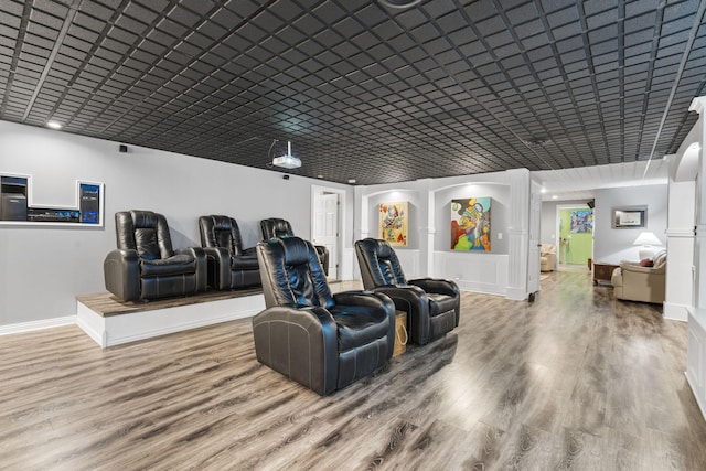 home theater with baseboards and wood finished floors