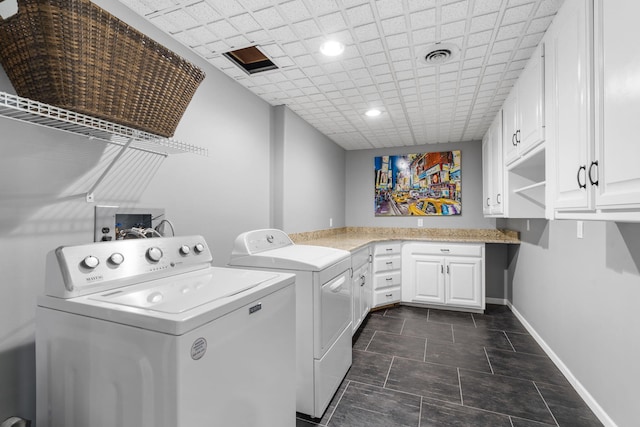 washroom featuring washer and dryer, cabinet space, visible vents, and baseboards