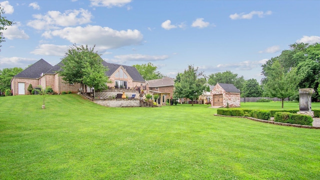 view of yard featuring a storage shed, fence, and an outdoor structure