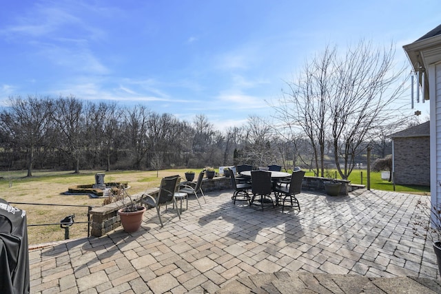 view of patio / terrace with an outdoor fire pit, area for grilling, and outdoor dining space