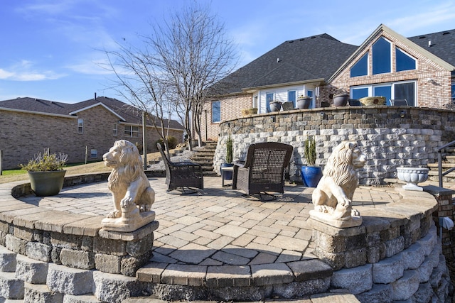 view of patio / terrace with stairs and an outdoor fire pit