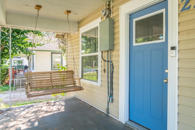 view of exterior entry with a porch