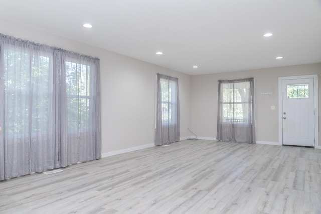 interior space featuring recessed lighting, wood finished floors, visible vents, and baseboards