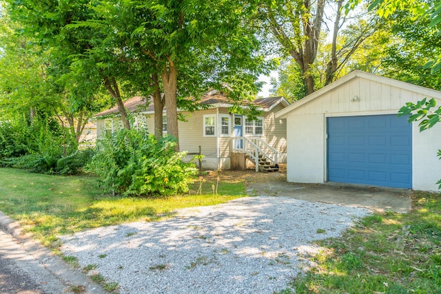 view of front facade with an outbuilding, gravel driveway, and a garage