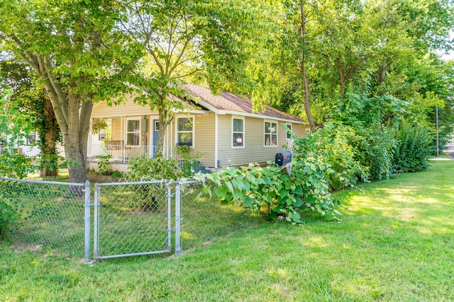 view of front of property with a gate, fence, a porch, and a front yard