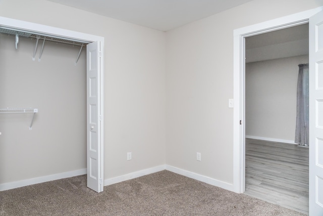 unfurnished bedroom with carpet floors and baseboards