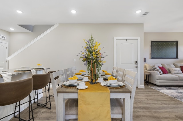 dining space featuring stairs, visible vents, wood finished floors, and recessed lighting