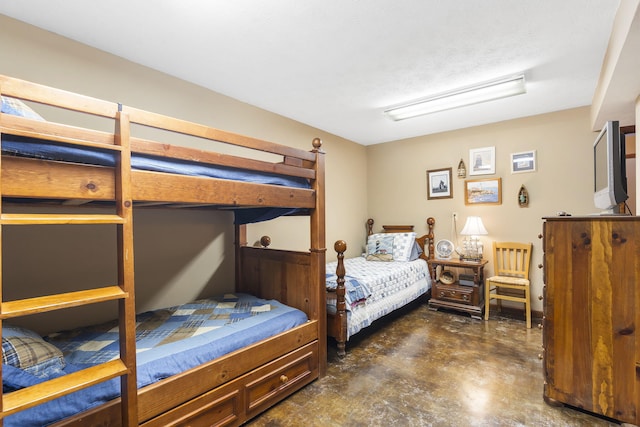 bedroom featuring concrete floors