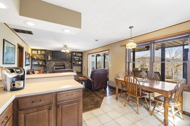 kitchen featuring a fireplace, visible vents, open floor plan, and light countertops