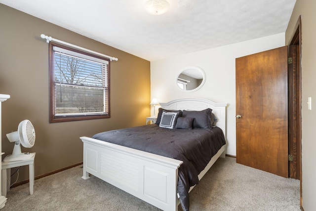 bedroom with light carpet and baseboards