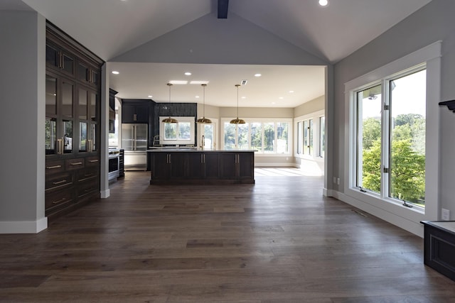 kitchen with lofted ceiling with beams, high quality fridge, open floor plan, and dark wood-style flooring