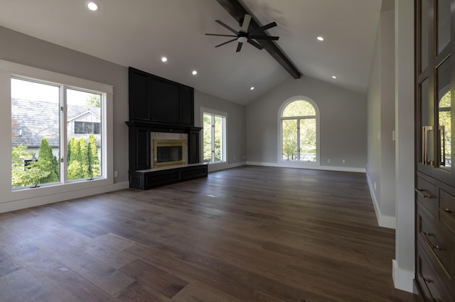 unfurnished living room featuring vaulted ceiling with beams, recessed lighting, dark wood-type flooring, a large fireplace, and baseboards