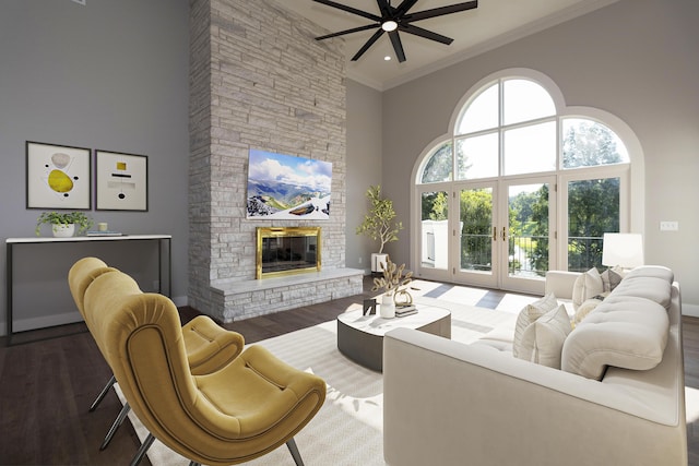 living room with wood finished floors, a high ceiling, crown molding, french doors, and a fireplace