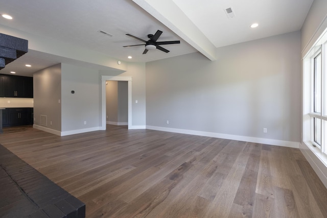 unfurnished living room featuring recessed lighting, wood finished floors, beam ceiling, and baseboards