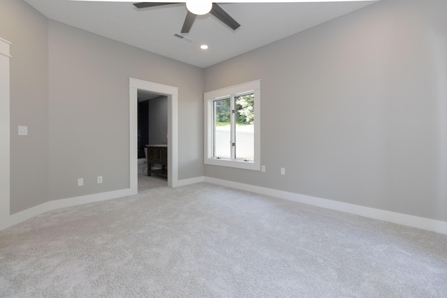 unfurnished bedroom featuring baseboards, visible vents, light colored carpet, ensuite bath, and recessed lighting