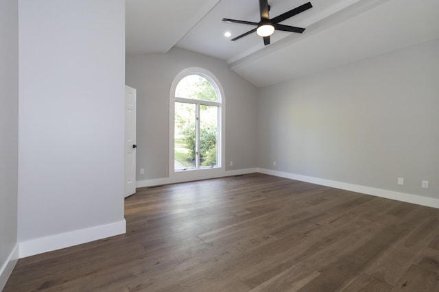 empty room featuring dark wood-type flooring, visible vents, a ceiling fan, vaulted ceiling, and baseboards