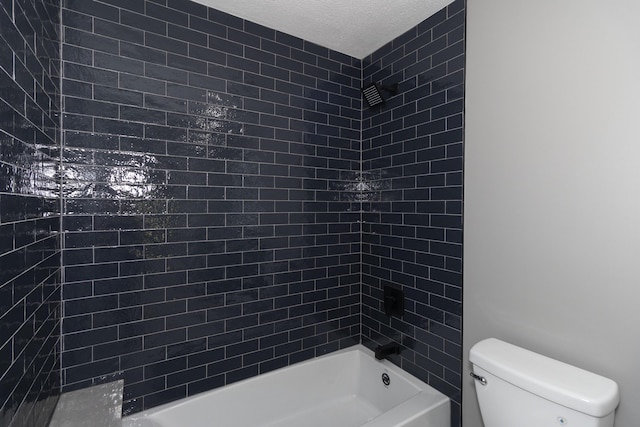 full bath with tub / shower combination, a textured ceiling, and toilet