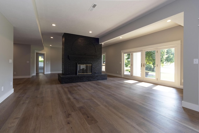 unfurnished living room featuring recessed lighting, a fireplace, baseboards, and wood finished floors