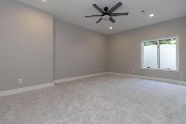 empty room with recessed lighting, visible vents, light colored carpet, a ceiling fan, and baseboards