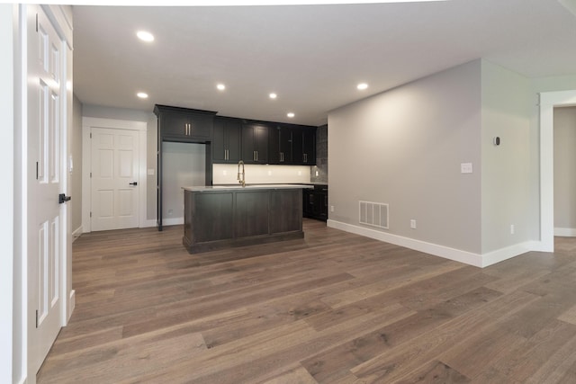 kitchen with baseboards, visible vents, wood finished floors, and recessed lighting