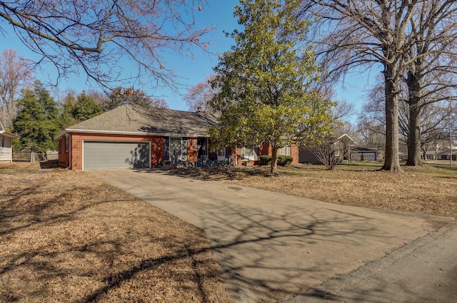 view of front of house featuring concrete driveway, brick siding, and an attached garage