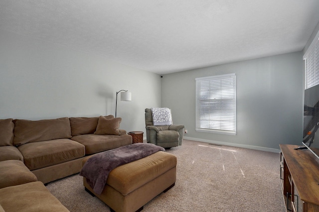 living room with carpet, visible vents, baseboards, and a textured ceiling