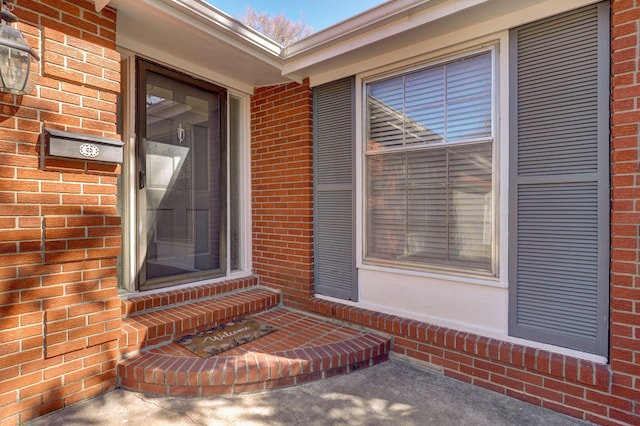 property entrance with brick siding