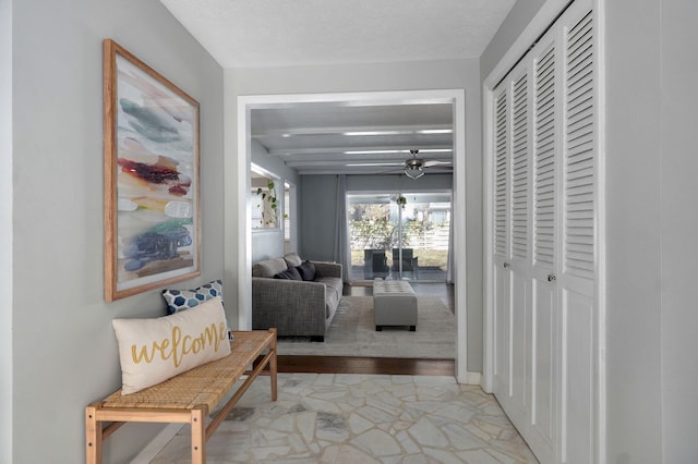 corridor featuring marble finish floor