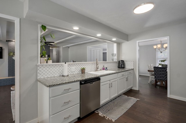 kitchen featuring backsplash, dark wood-type flooring, white cabinets, a sink, and dishwasher