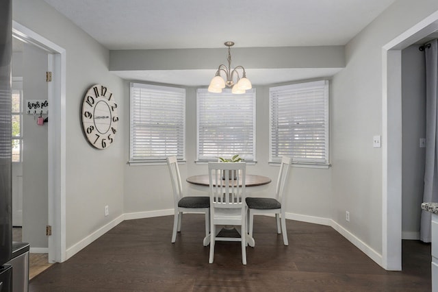 dining area with a chandelier, plenty of natural light, and dark wood-style floors