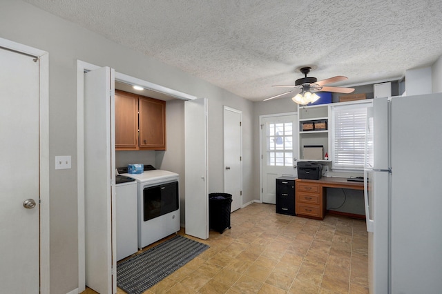 kitchen featuring washer and clothes dryer, a ceiling fan, light countertops, freestanding refrigerator, and brown cabinetry