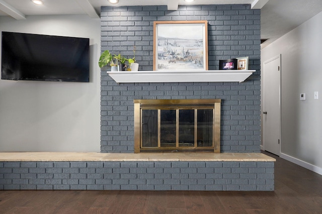 interior details featuring recessed lighting, a fireplace, wood finished floors, baseboards, and beam ceiling