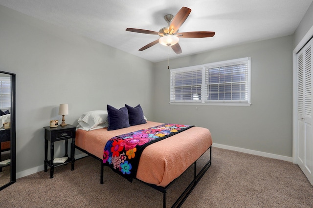 carpeted bedroom with a ceiling fan, baseboards, and a closet