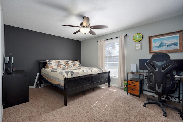 bedroom with light carpet, ceiling fan, and baseboards