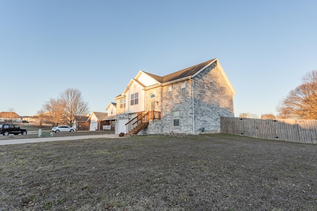 view of property exterior with a yard and fence