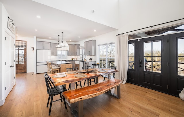 dining room featuring light wood-style floors, a wealth of natural light, and recessed lighting