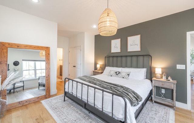 bedroom featuring recessed lighting, baseboards, a notable chandelier, and light wood finished floors