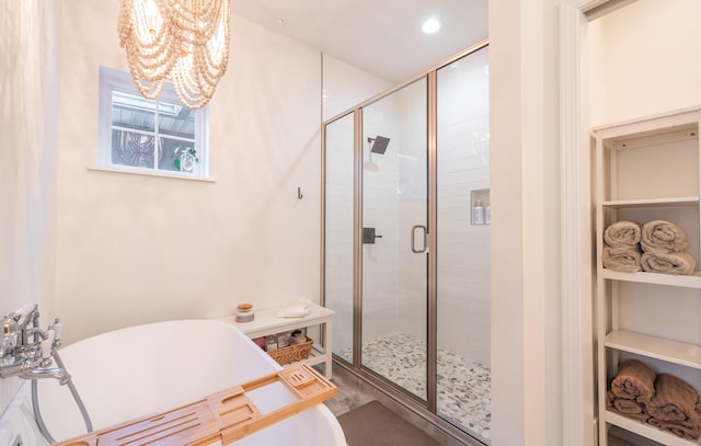 full bath featuring a stall shower, recessed lighting, and a soaking tub