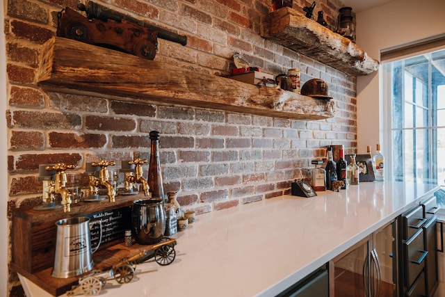 bar with brick wall, a dry bar, and wine cooler