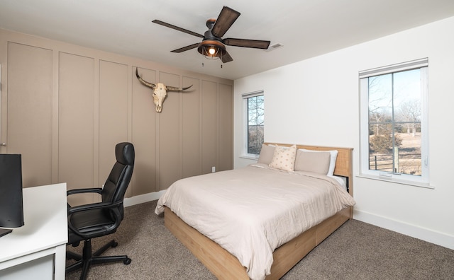 carpeted bedroom featuring visible vents, ceiling fan, and baseboards