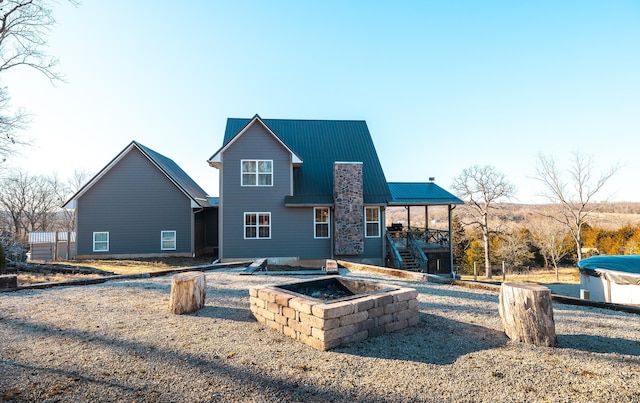 back of property featuring metal roof and stairway