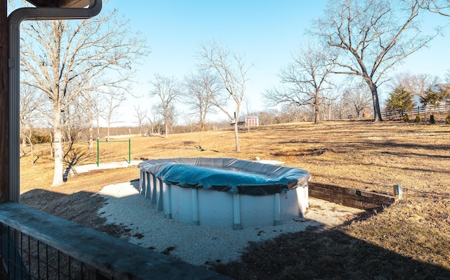 view of yard featuring a covered pool and a rural view