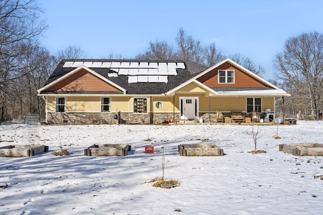 view of front of home with covered porch and solar panels