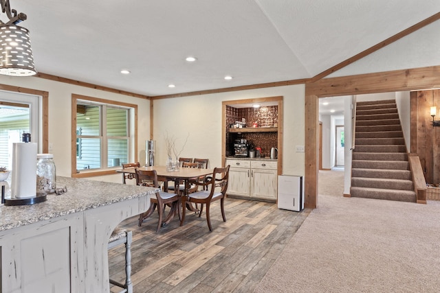 dining room featuring light wood finished floors, stairway, and recessed lighting