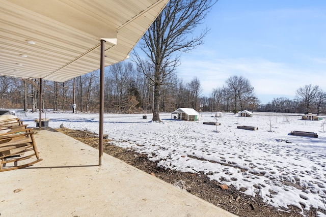 yard covered in snow with an outdoor structure