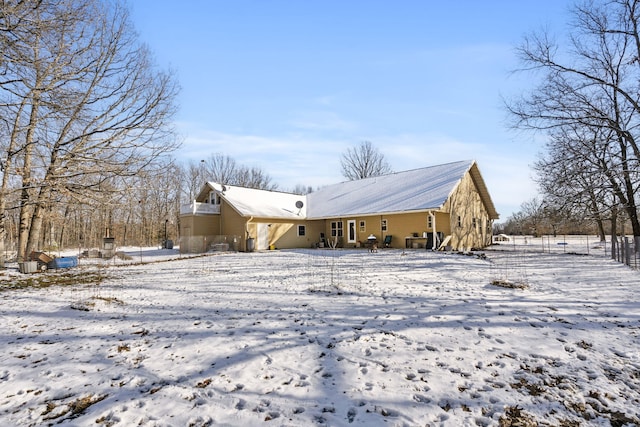 view of snow covered rear of property